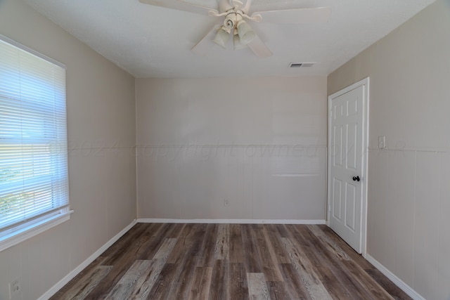 spare room featuring ceiling fan and dark hardwood / wood-style flooring