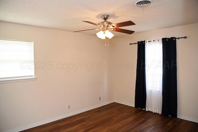 220 Hickory St, Hereford, TX 79045 - spare room featuring ceiling fan, dark wood-style flooring, and a textured ceiling