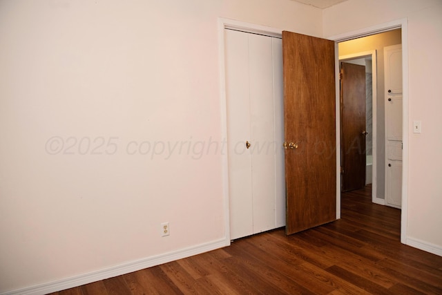220 Hickory St, Hereford, TX 79045 - unfurnished bedroom featuring dark wood-type flooring and a closet
