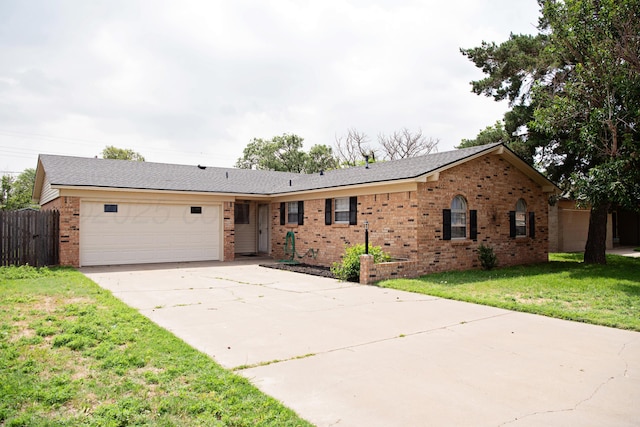 220 Hickory St, Hereford, TX 79045 - ranch-style home with brick siding, a garage, and driveway