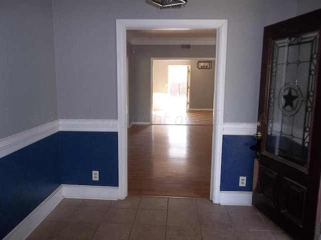 interior space featuring hardwood / wood-style floors and crown molding