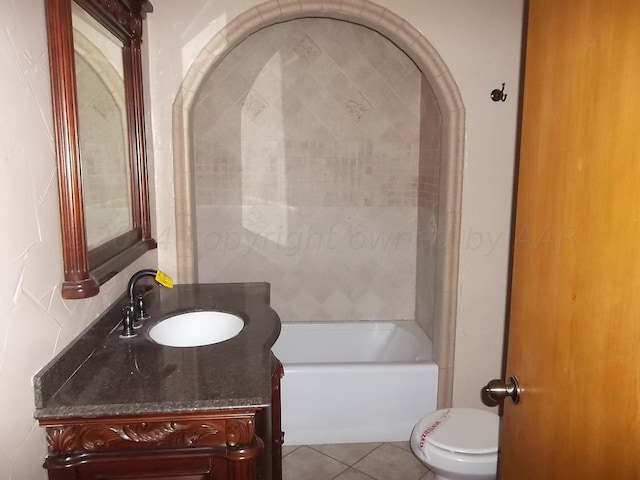 bathroom with tile patterned flooring, vanity, toilet, and a bath