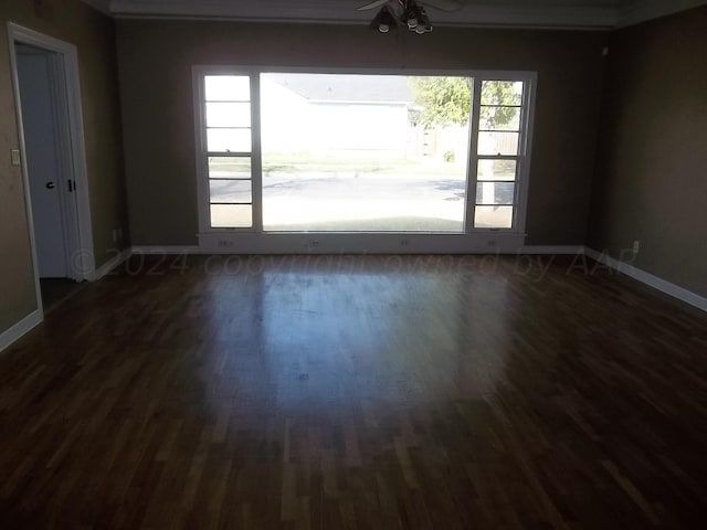 empty room featuring dark wood-type flooring and ceiling fan