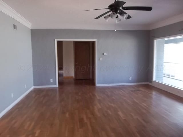 empty room featuring dark wood-type flooring, ceiling fan, and crown molding