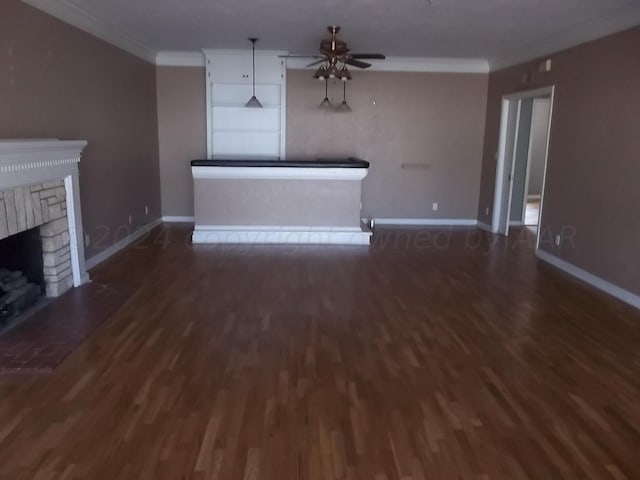 unfurnished living room featuring dark hardwood / wood-style floors, crown molding, and ceiling fan