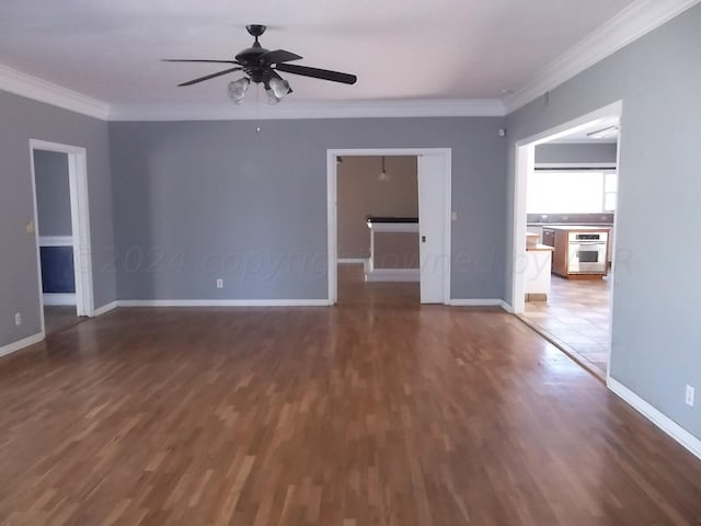 spare room featuring ceiling fan, dark hardwood / wood-style floors, and crown molding