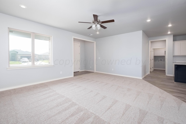 spare room featuring carpet flooring and ceiling fan