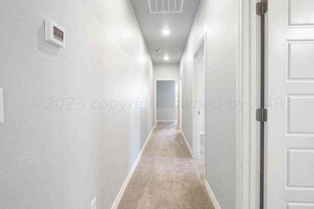 hallway with light colored carpet