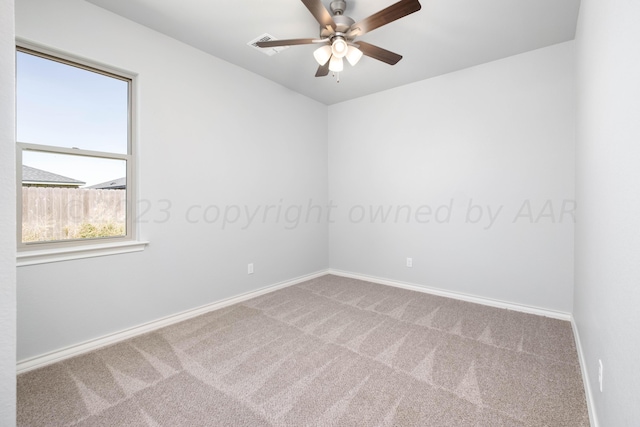 carpeted spare room with ceiling fan