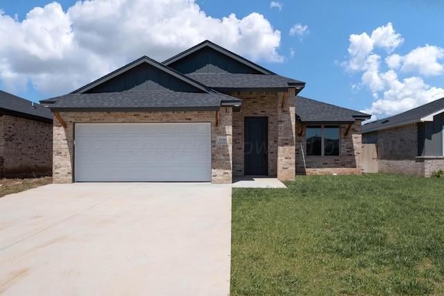 view of front of property with a garage and a front lawn