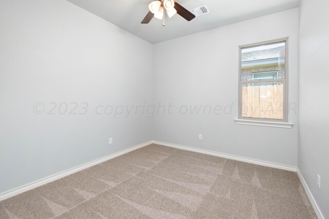 carpeted spare room featuring ceiling fan