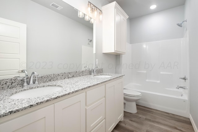 full bathroom featuring vanity, toilet, tub / shower combination, and hardwood / wood-style floors