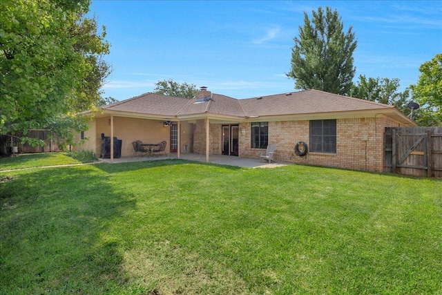 7104 Old Kent Rd, Amarillo, TX 79109 - back of house with a fenced backyard, a patio, a chimney, brick siding, and roof with shingles