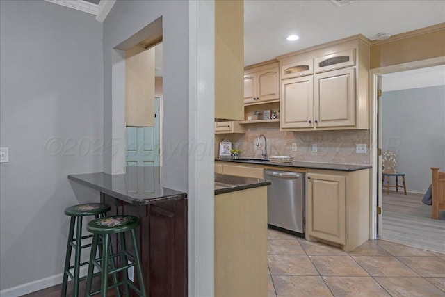 7104 Old Kent Rd, Amarillo, TX 79109 - kitchen with a breakfast bar, ornamental molding, backsplash, dishwasher, and a peninsula