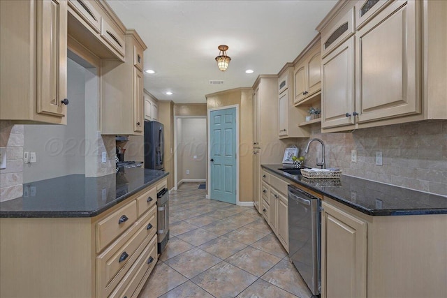 7104 Old Kent Rd, Amarillo, TX 79109 - kitchen featuring tasteful backsplash, recessed lighting, light tile patterned flooring, stainless steel dishwasher, and black fridge