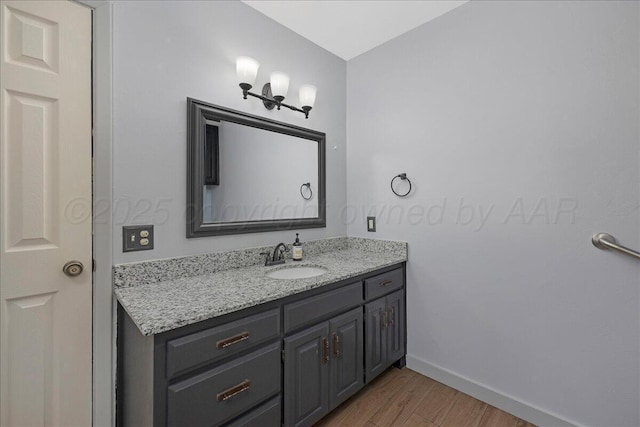 7104 Old Kent Rd, Amarillo, TX 79109 - bathroom featuring wood finished floors and vanity