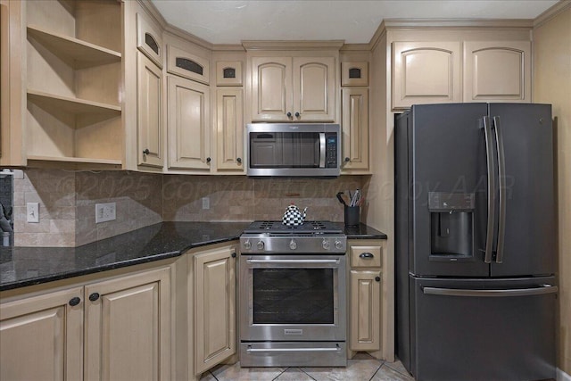 7104 Old Kent Rd, Amarillo, TX 79109 - kitchen featuring appliances with stainless steel finishes, cream cabinetry, open shelves, dark stone countertops, and backsplash