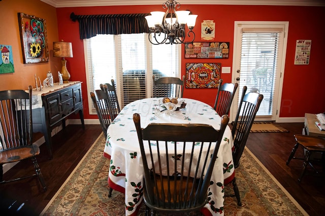 dining room featuring dark wood-type flooring, a notable chandelier, and ornamental molding