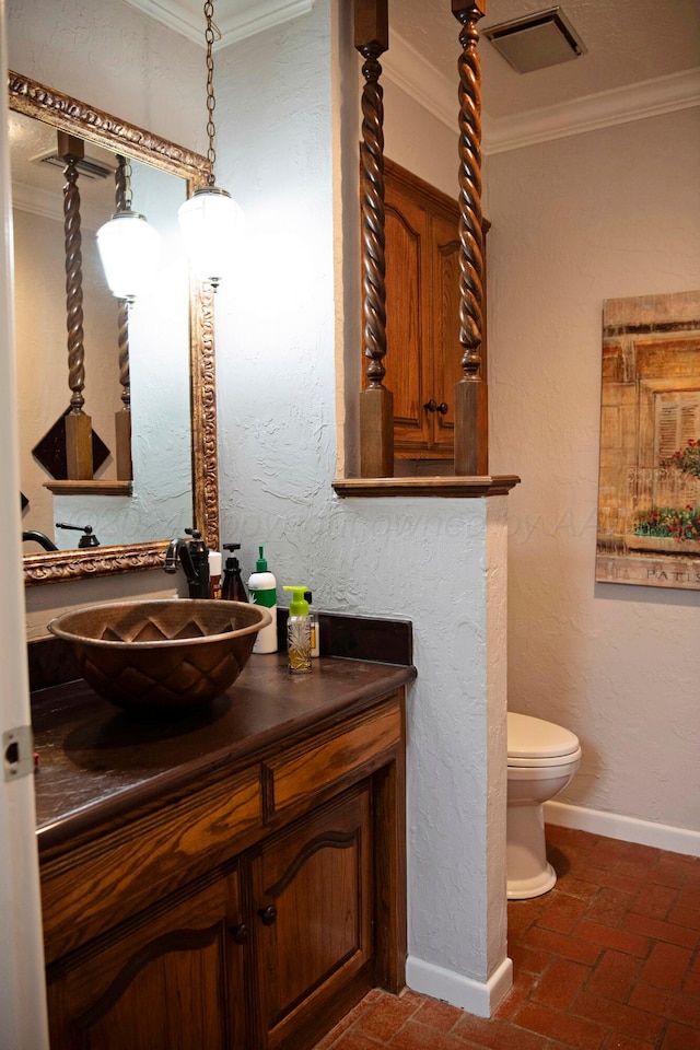 bathroom featuring vanity, toilet, and crown molding