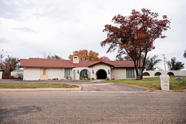 view of front of home with a garage and a front yard