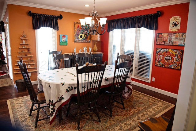 dining space featuring a notable chandelier, dark hardwood / wood-style flooring, and ornamental molding