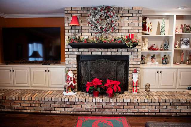 living room featuring hardwood / wood-style floors, crown molding, and a fireplace