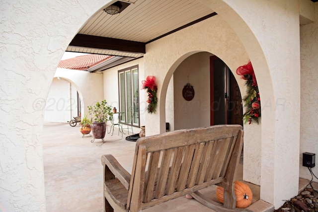 view of exterior entry with a patio