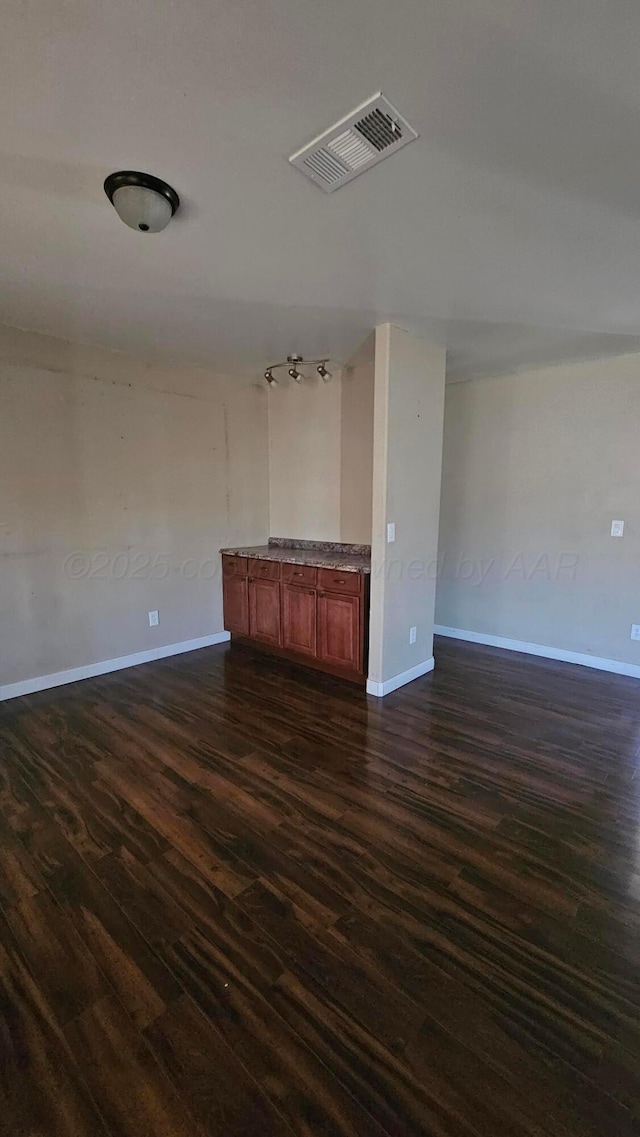 1300 Patton Cir, Borger, TX 79007 - spare room featuring dark wood finished floors and baseboards