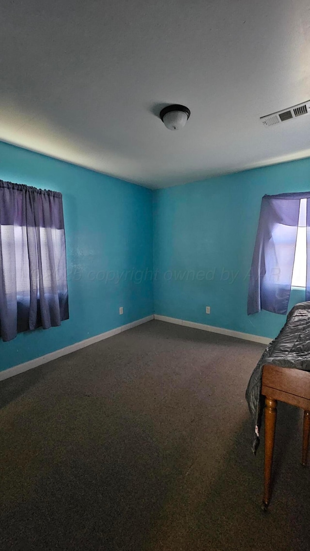 1300 Patton Cir, Borger, TX 79007 - spare room featuring carpet flooring and baseboards