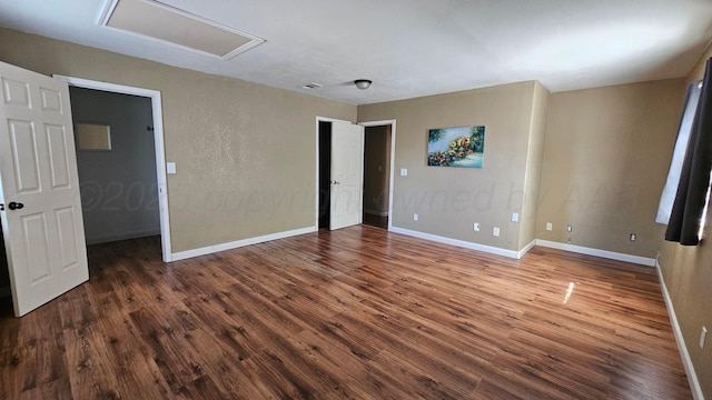 1300 Patton Cir, Borger, TX 79007 - empty room with attic access, wood finished floors, and a textured wall