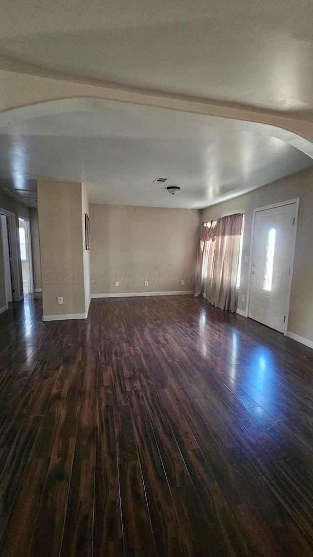 1300 Patton Cir, Borger, TX 79007 - unfurnished living room featuring dark wood finished floors and baseboards