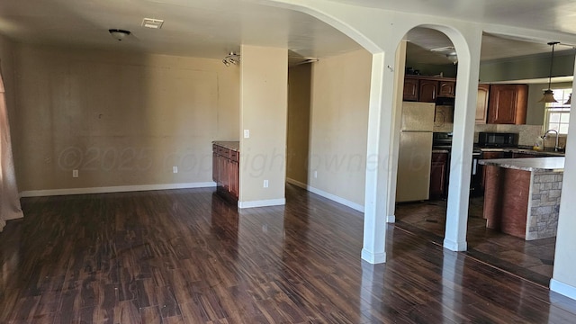1300 Patton Cir, Borger, TX 79007 - kitchen with black microwave, freestanding refrigerator, dark wood-style flooring, and open floor plan