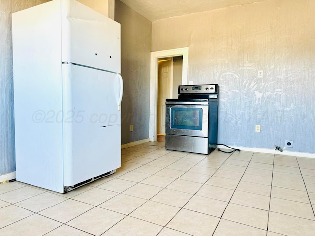 2400 SW 4th Ave, Amarillo, TX 79106 - kitchen with baseboards, freestanding refrigerator, and stainless steel range with electric cooktop
