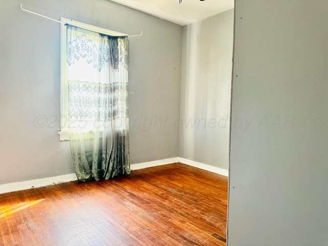 2400 SW 4th Ave, Amarillo, TX 79106 - spare room with baseboards and hardwood / wood-style floors