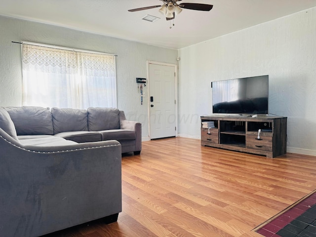 2400 SW 4th Ave, Amarillo, TX 79106 - living area with visible vents, baseboards, a ceiling fan, and wood finished floors