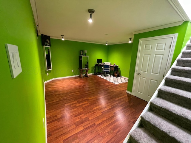 interior space with crown molding, stairs, wood finished floors, baseboards, and an office area
