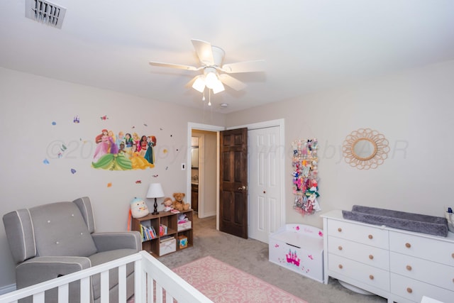 bedroom featuring a closet, light colored carpet, and ceiling fan