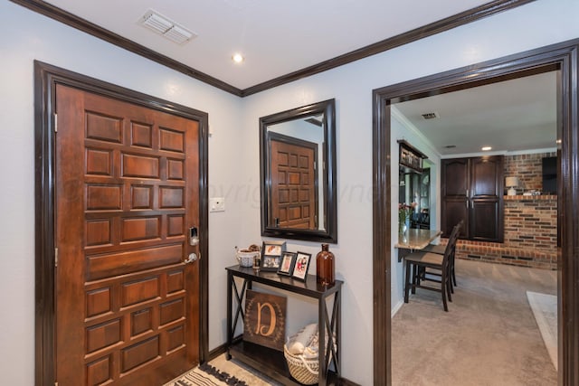 carpeted entrance foyer with crown molding, baseboards, and recessed lighting