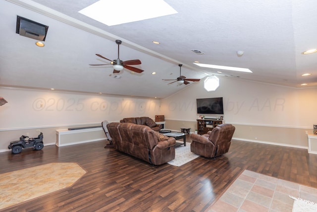 living area featuring a skylight, wood finished floors, lofted ceiling, ceiling fan, and recessed lighting