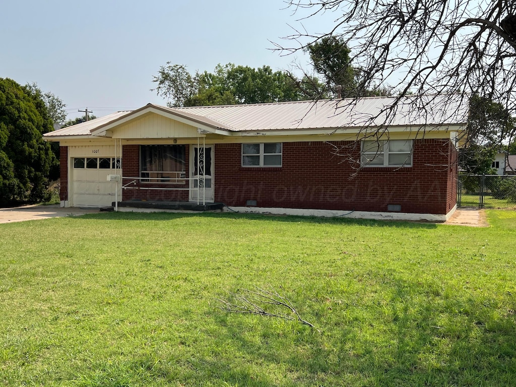 ranch-style home with a front lawn and a garage