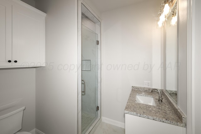 bathroom with vanity, toilet, and a shower with shower door