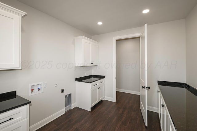 washroom with cabinets, hookup for an electric dryer, washer hookup, and dark hardwood / wood-style flooring