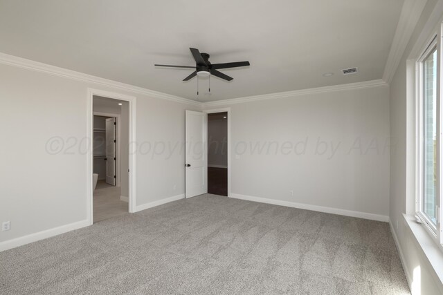 unfurnished bedroom with ceiling fan, ornamental molding, and light carpet