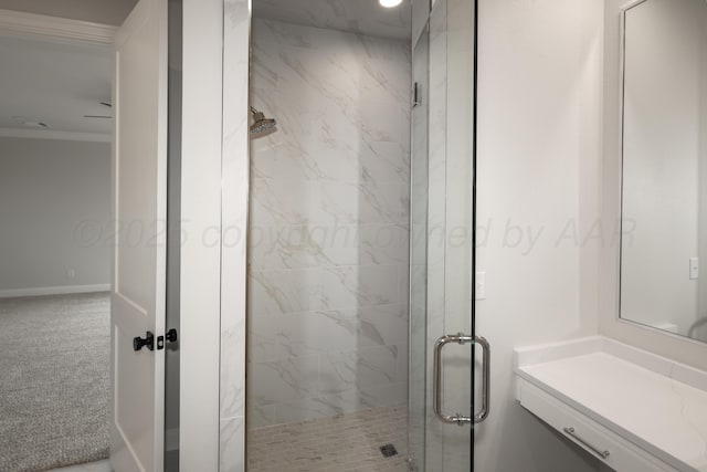 bathroom with ornamental molding and an enclosed shower