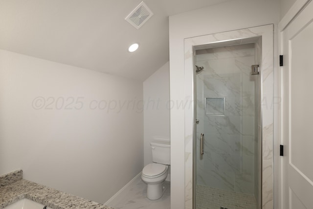 bathroom with vaulted ceiling, vanity, toilet, and a shower with door