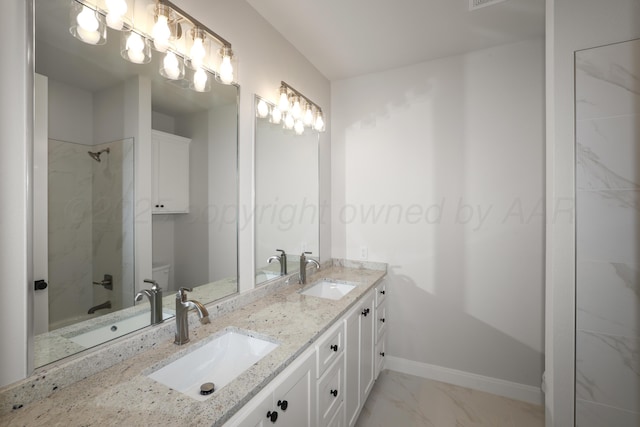 bathroom with tiled shower and vanity