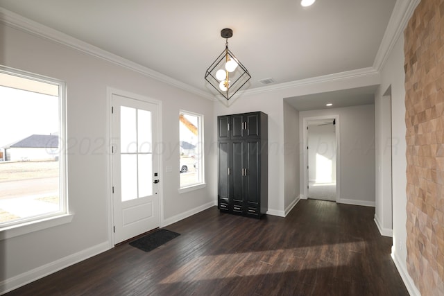 entrance foyer with ornamental molding and dark hardwood / wood-style flooring