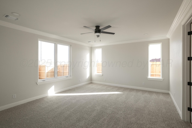 carpeted empty room featuring crown molding, ceiling fan, and a wealth of natural light