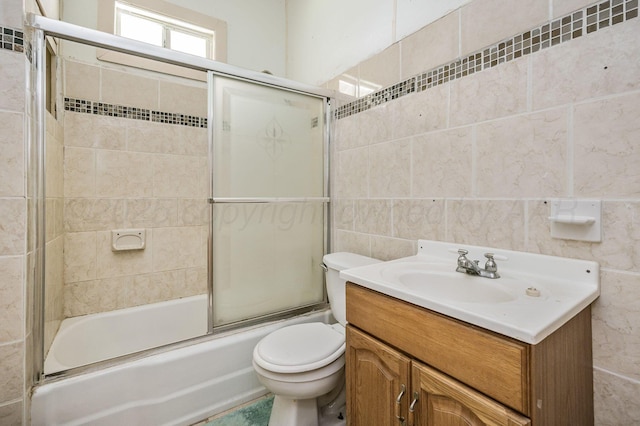 102 S Sumner St, Pampa, TX 79065 - bathroom with tile walls, toilet, bath / shower combo with glass door, and vanity