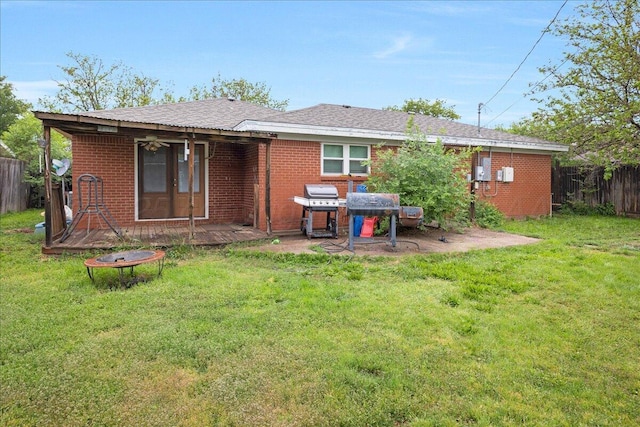 back of property featuring brick siding and a deck